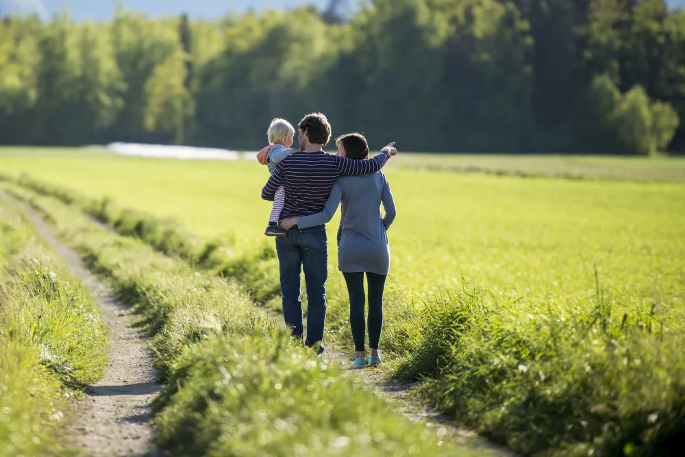 Family together at home, unposed, backs partly turned